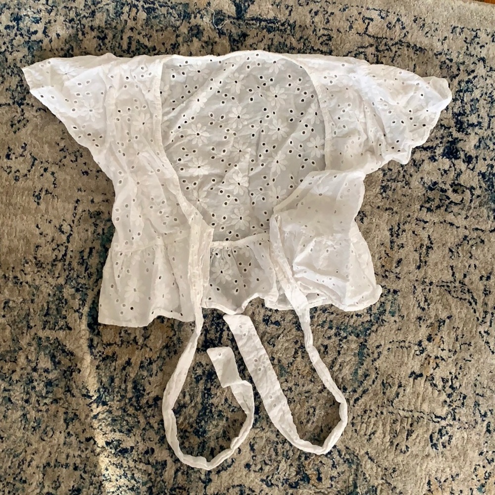 A cropped, tie, white blouse, with ruffled short sleeves